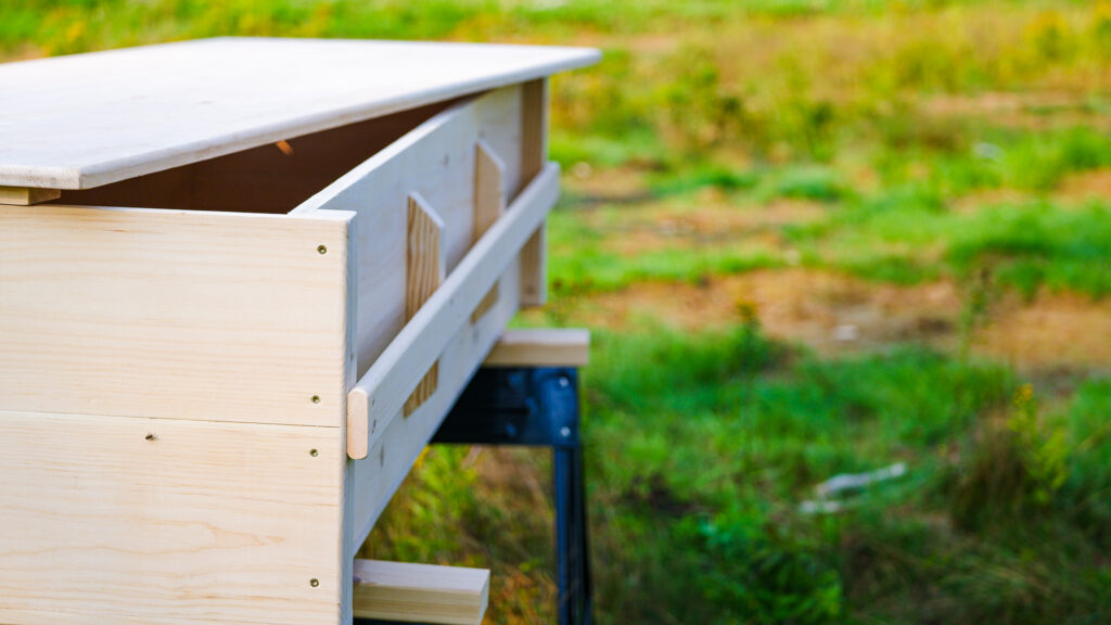 side view of finished casket showing hand rail. At of a bit of distance